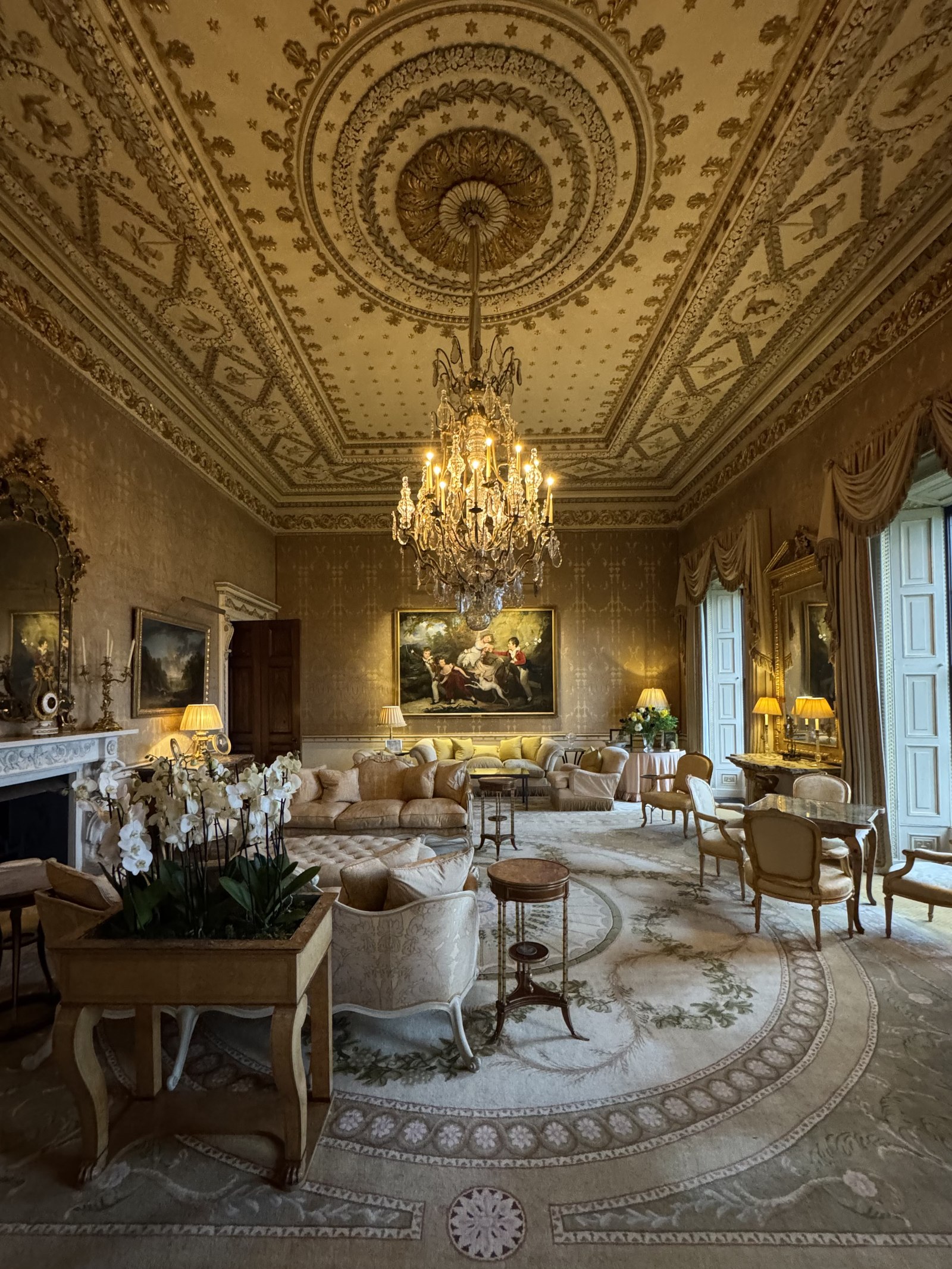 Grand drawing room with crystal chandelier and gilded mirror
