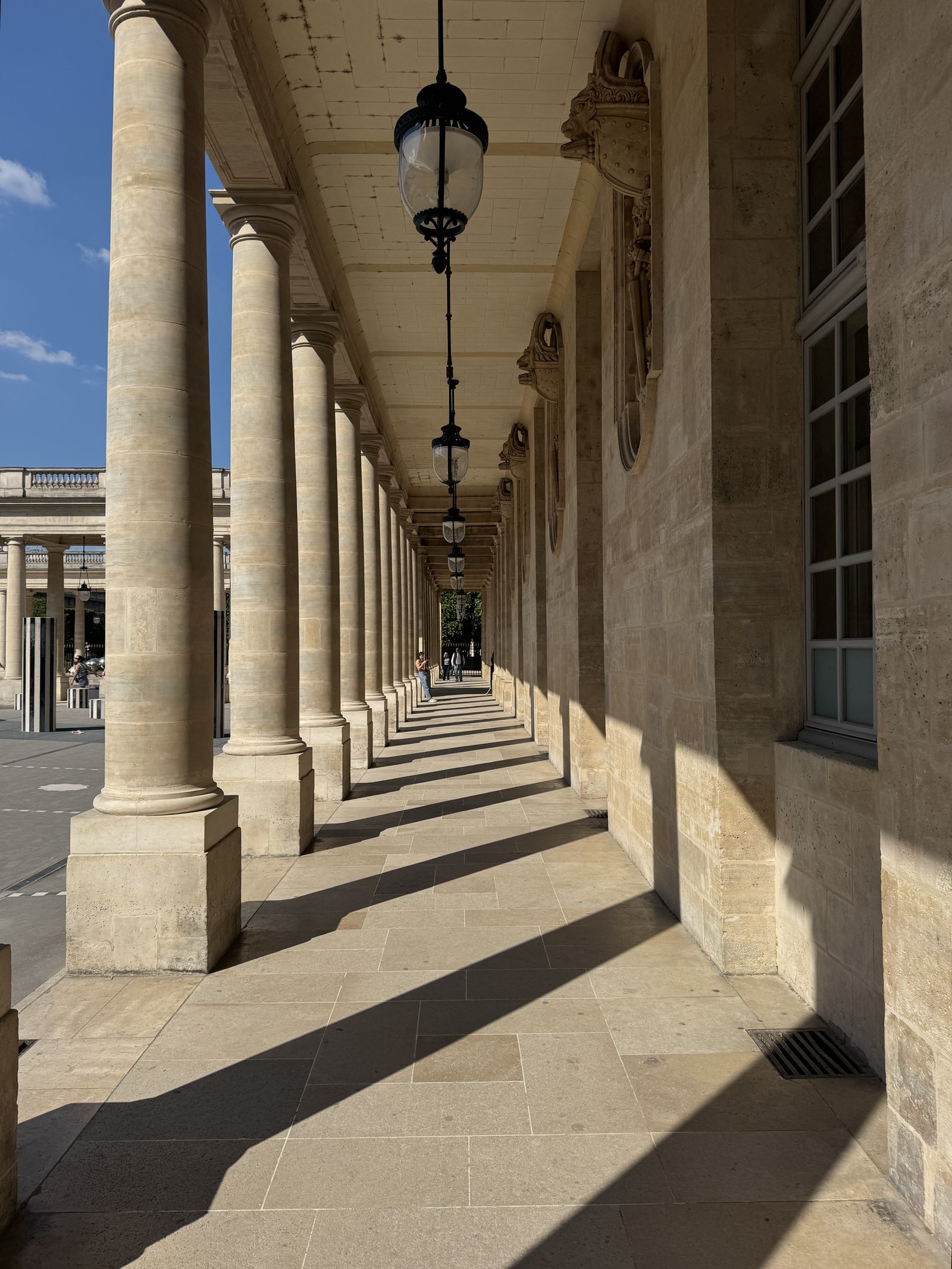 Sunlit stone colonnade with long shadows