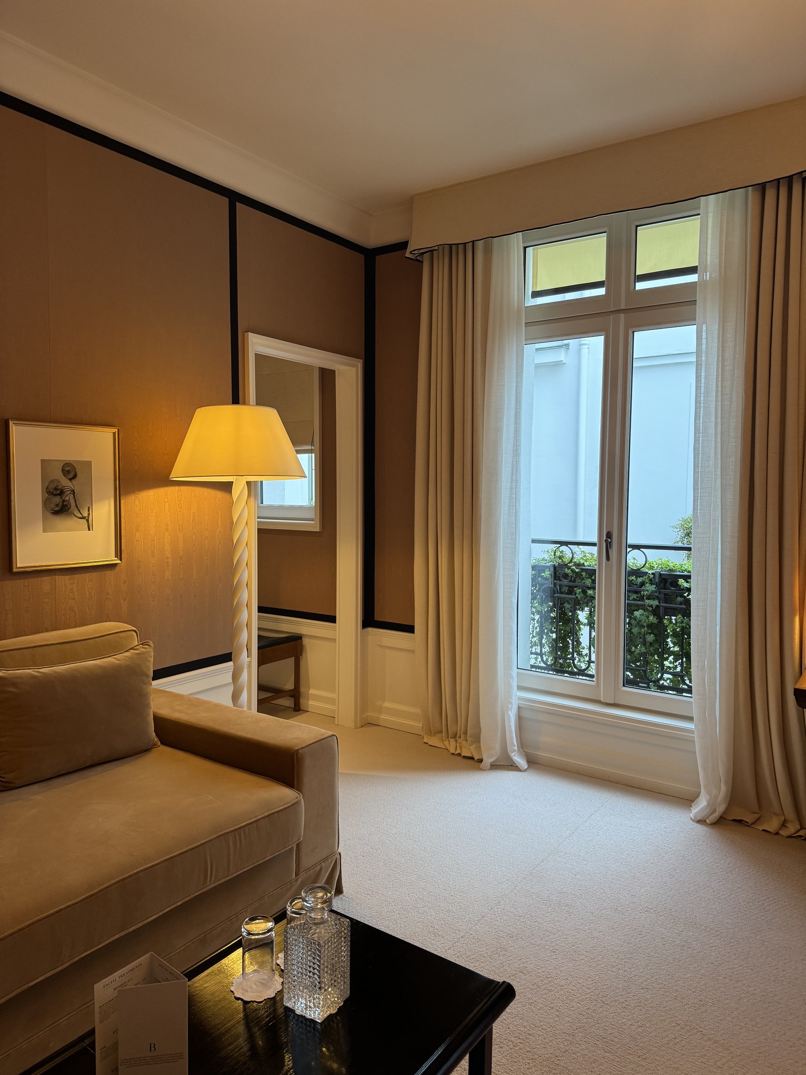 Quiet suite sitting area with desk by a window